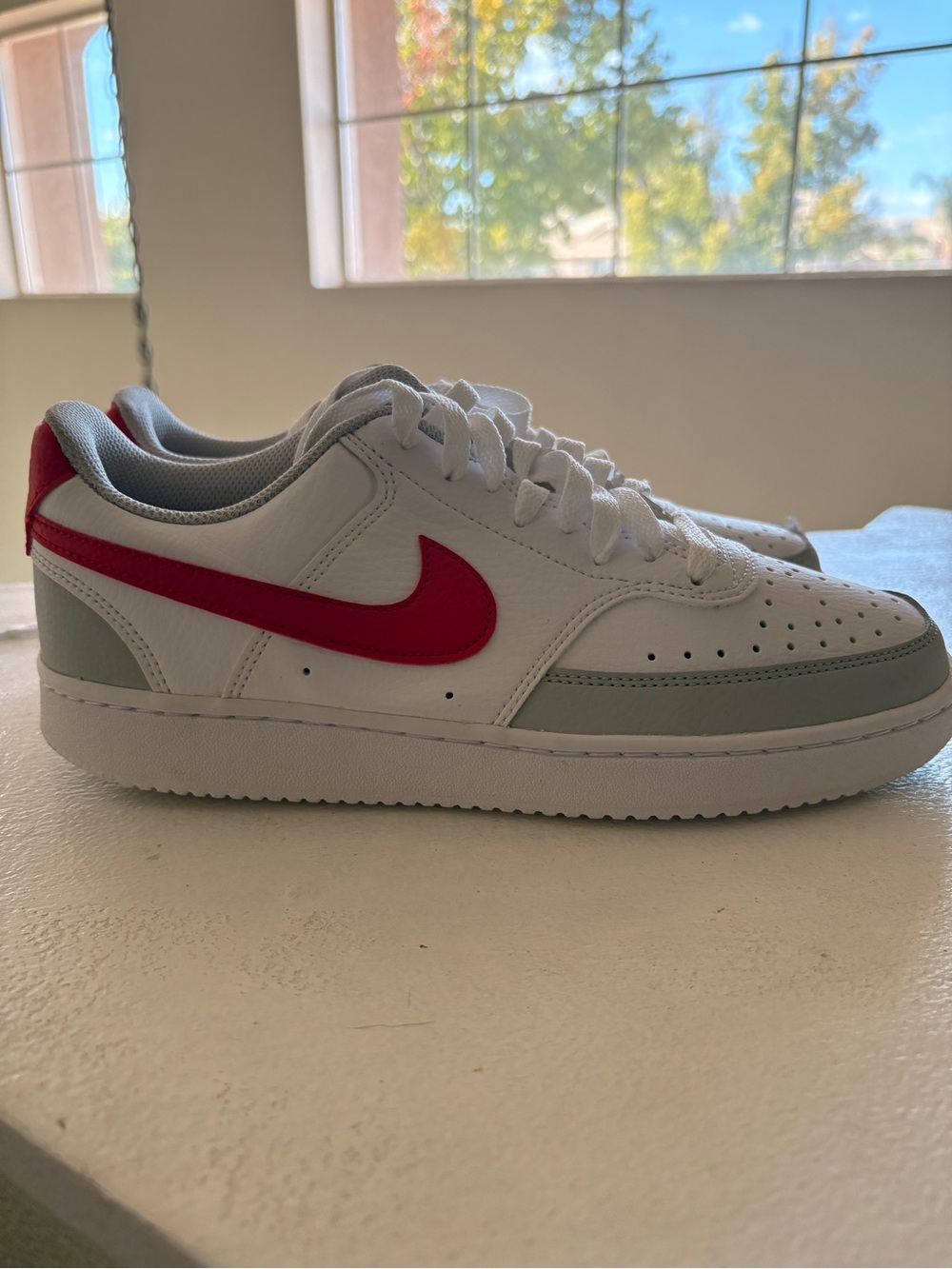 Nike White Low-Top Sneakers with Red Swoosh and Light Gray Accents